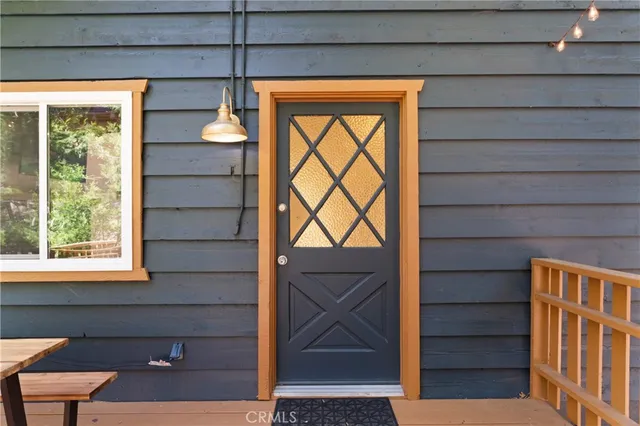a view of empty room with wooden floor and windows