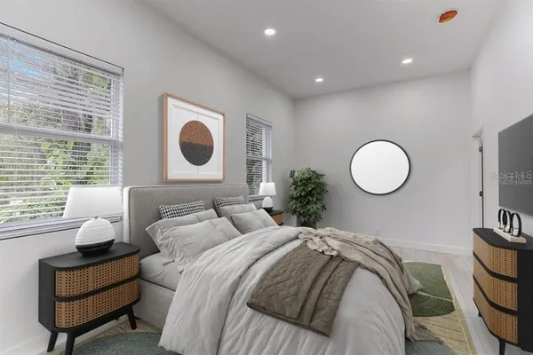 a bedroom with bed and a large window