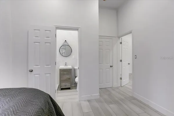 a bedroom with a bed and a chandelier