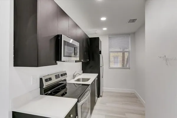 a kitchen that has a stove and a microwave