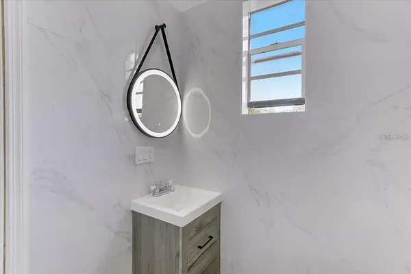 a bathroom with a sink and a mirror
