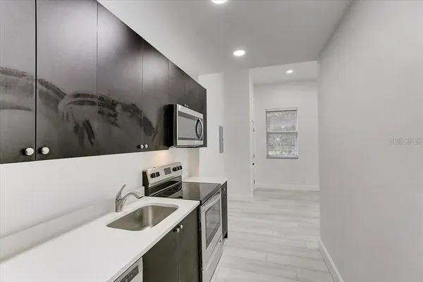 a kitchen with a sink and a microwave