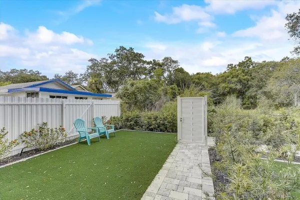 a backyard of a house with table and chairs