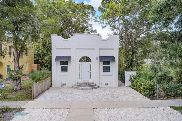 a view of house with backyard space and garden