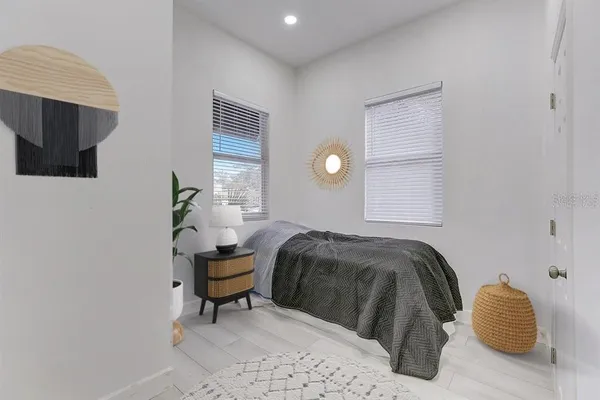 a bedroom with a bed and chair