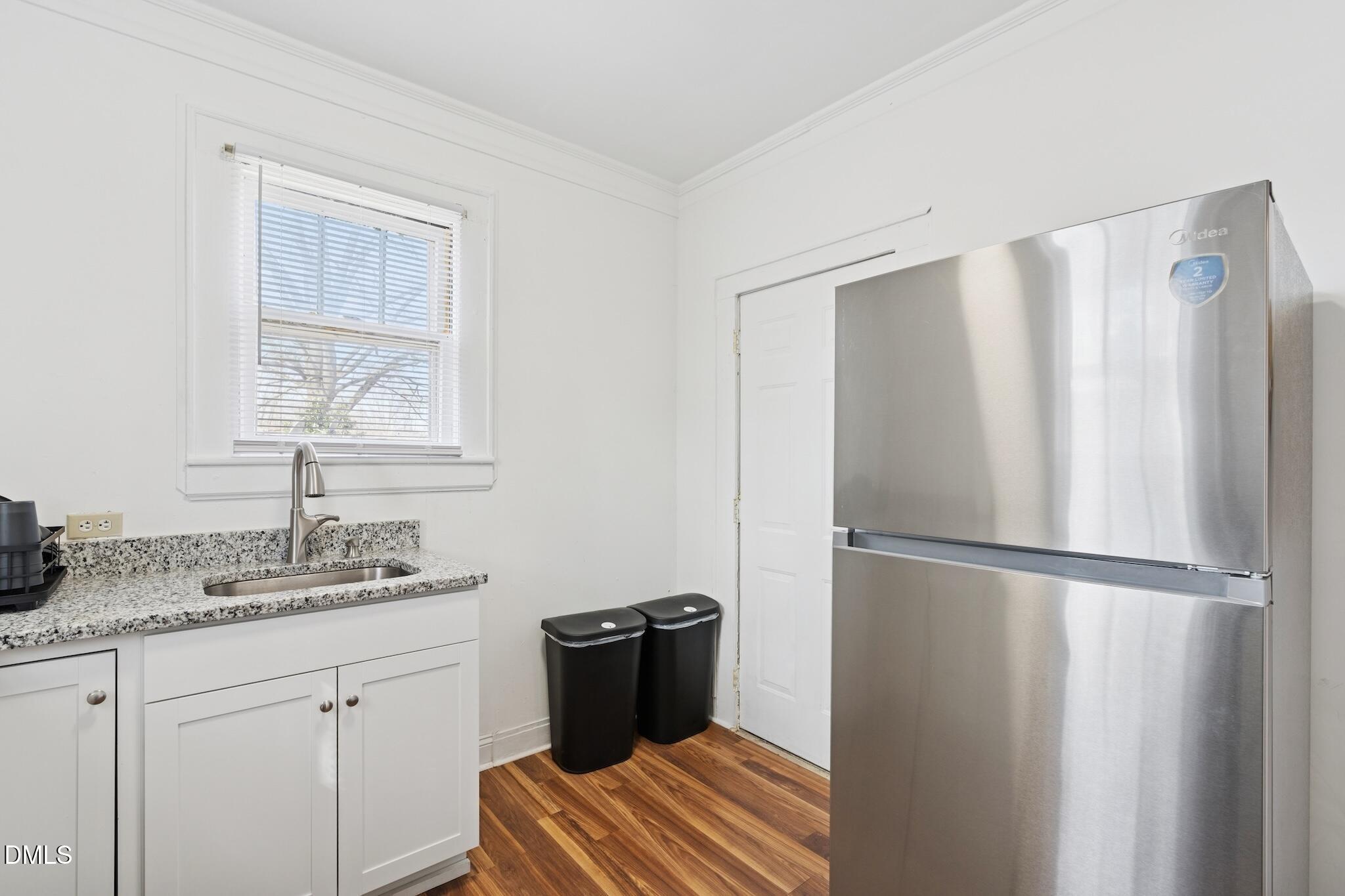 705 North Driver Street Durham, NC 27703 - Photo 41 of 46 a kitchen with a refrigerator and cabinets