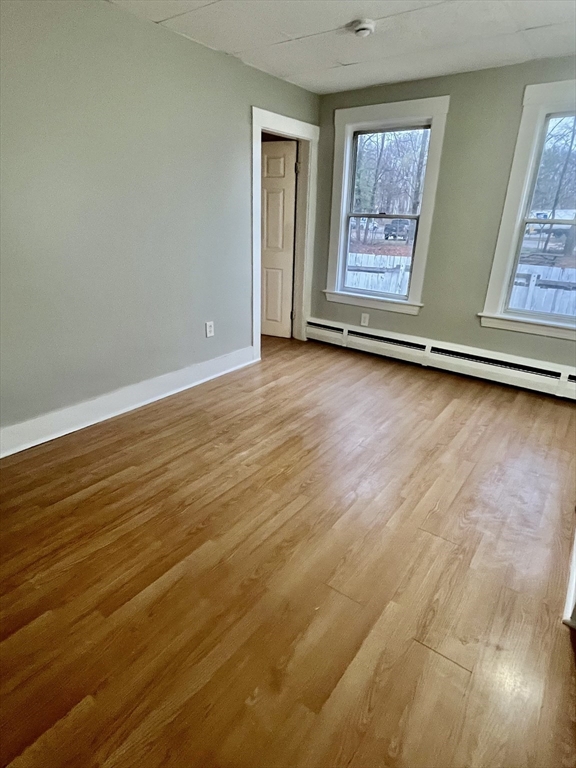 349 Main Street, Unit 2 Douglas, MA 01516 - Photo 8 of 11 a view of a room with wooden floor and window