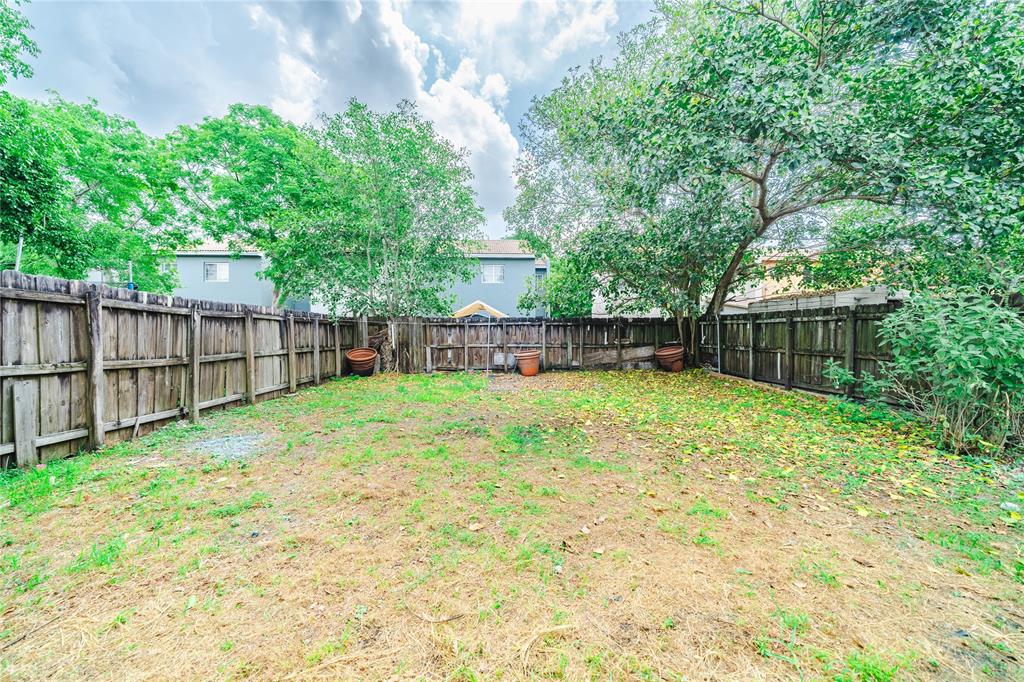 845 Southwest 6th Court Homestead, FL 33034 - Photo 13 of 30 a view of a backyard with a garden and trees
