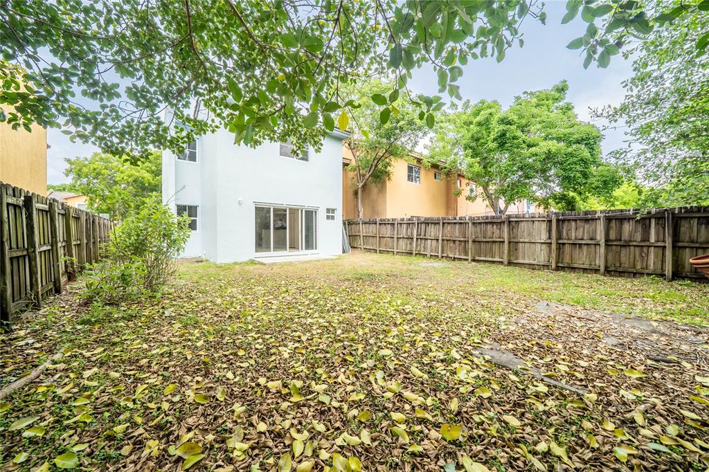 845 Southwest 6th Court Homestead, FL 33034 - Photo 14 of 30 a view of outdoor space with deck and trees