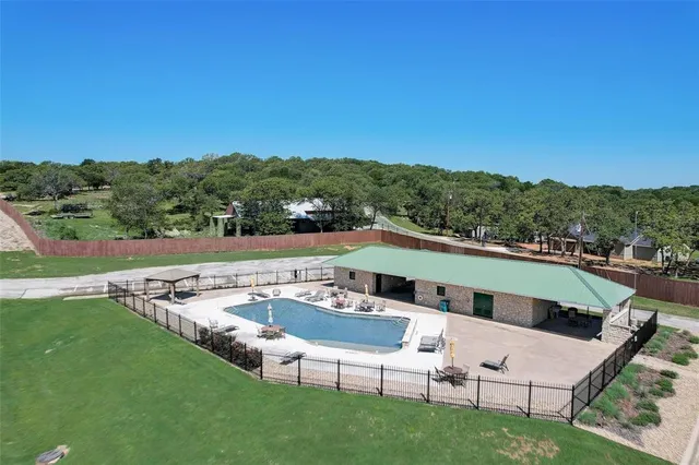 a view of a swimming pool with a yard