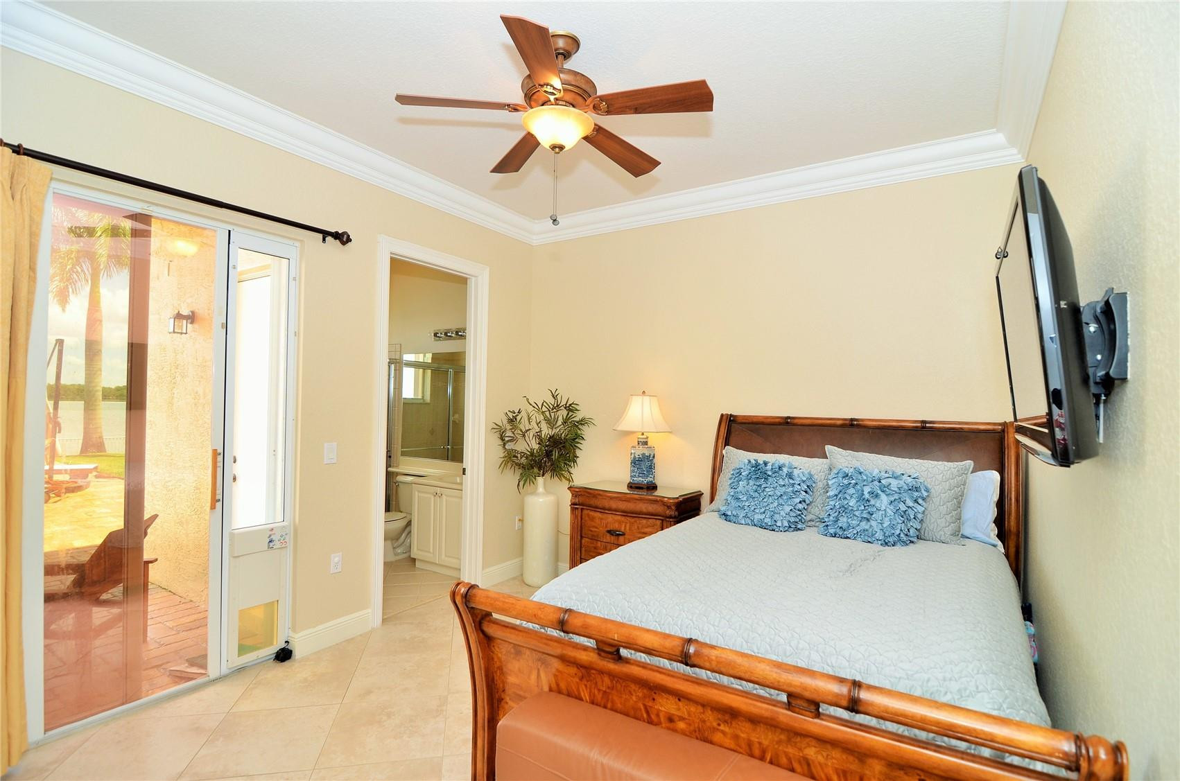 5436 Southwest 191st Terrace Miramar, FL 33029 - Photo 15 of 25 a bedroom with a large bed and a chandelier