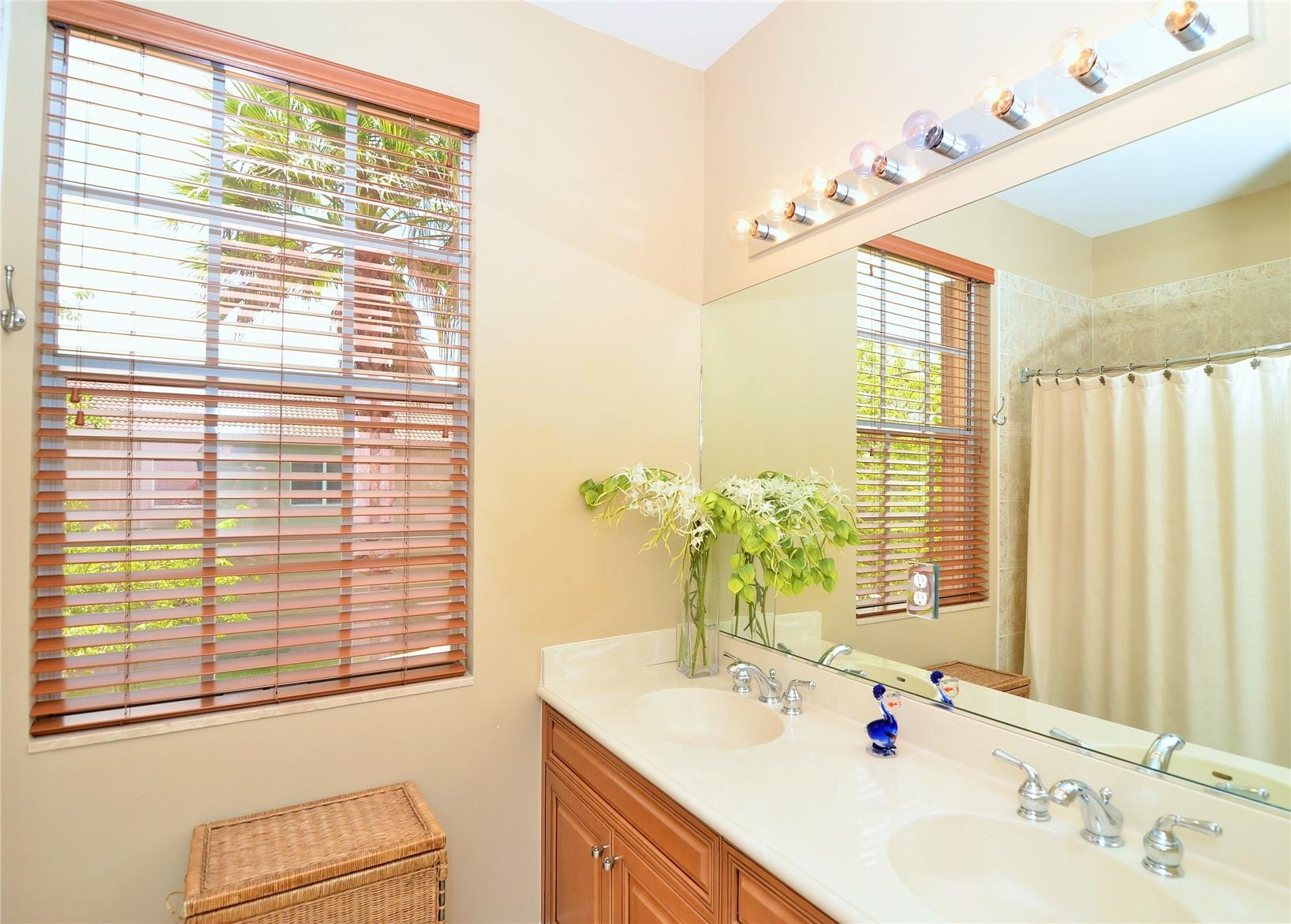 5436 Southwest 191st Terrace Miramar, FL 33029 - Photo 20 of 25 a bathroom with a sink and a large mirror