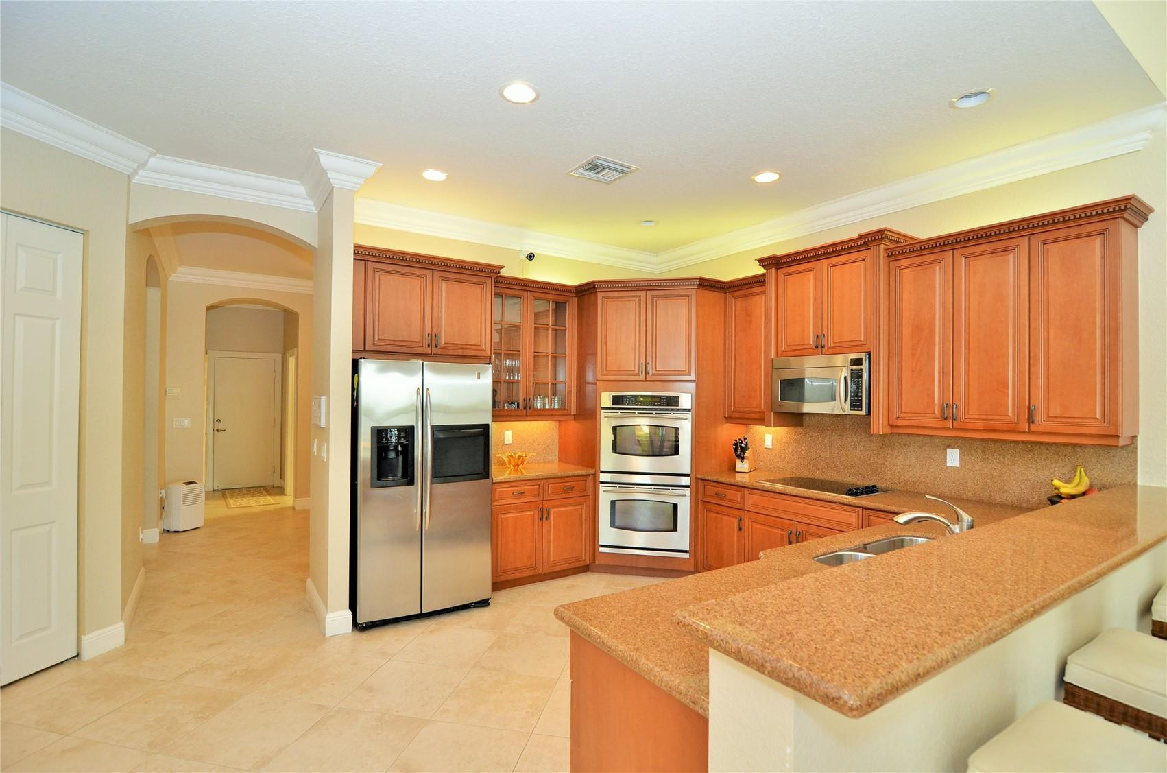 5436 Southwest 191st Terrace Miramar, FL 33029 - Photo 6 of 25 a kitchen with stainless steel appliances granite countertop a refrigerator and a sink