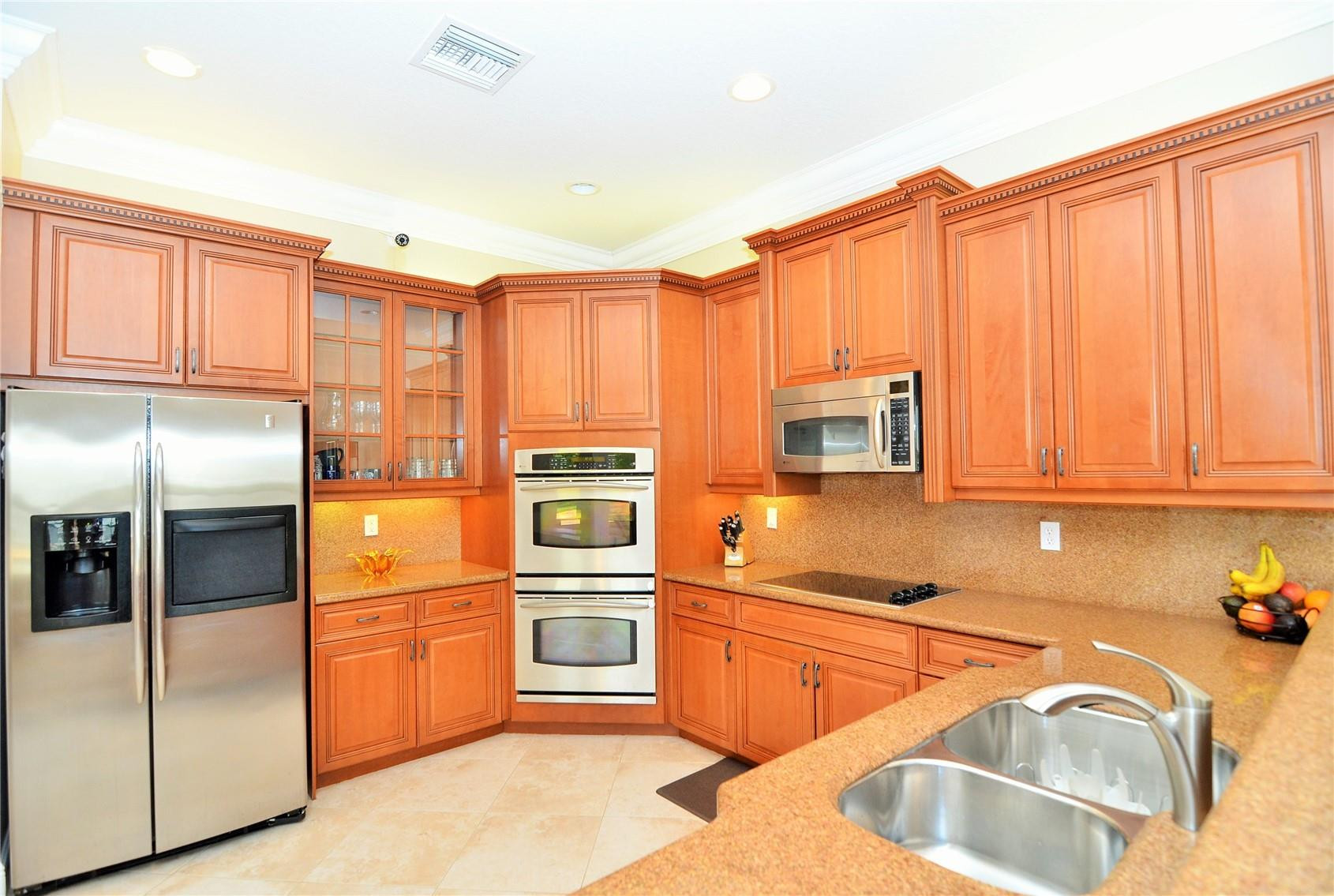 5436 Southwest 191st Terrace Miramar, FL 33029 - Photo 7 of 25 a kitchen with stainless steel appliances granite countertop a refrigerator a stove and a sink with cabinets