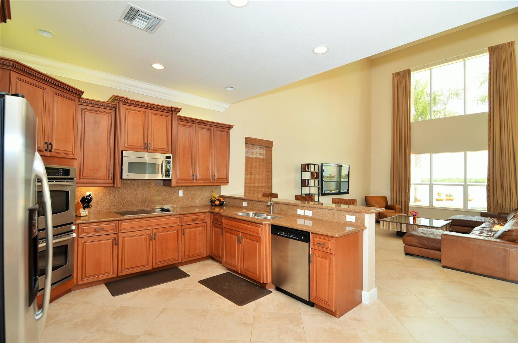 5436 Southwest 191st Terrace Miramar, FL 33029 - Photo 8 of 25 a kitchen with stainless steel appliances granite countertop a sink counter space cabinets and a large window