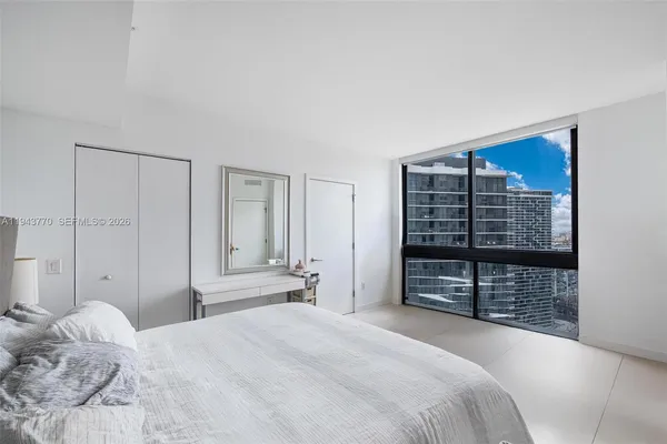 a bedroom with a bed and a walk in closet