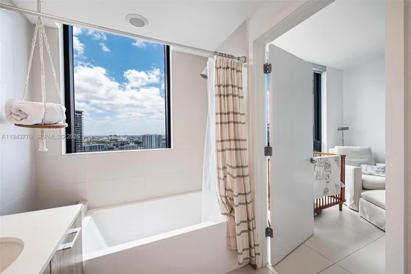 a bathroom with a bathtub and a shower