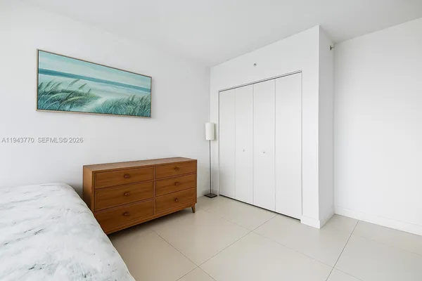 a room with a dresser and a painting