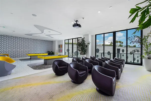 a living room with furniture a ceiling fan and a bathtub