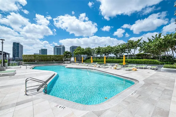 a view of a swimming pool and a longer chairs