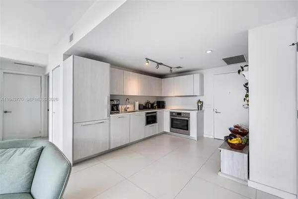 a kitchen with cabinets and white appliances