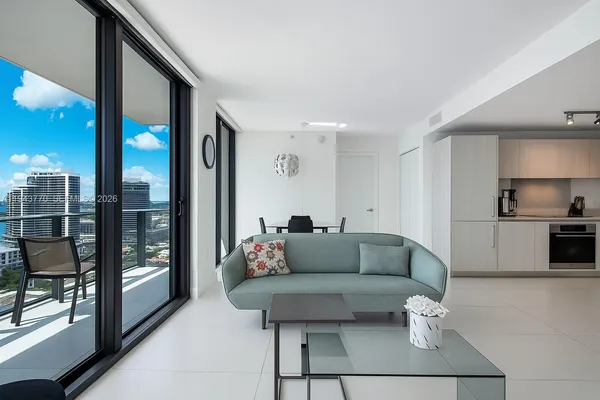 a living room with furniture and a large window