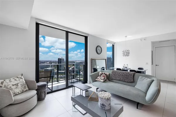 a living room with furniture and a large window