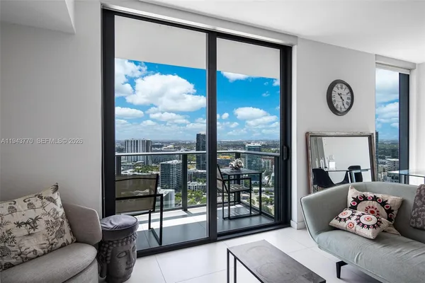 a living room with furniture and a large window