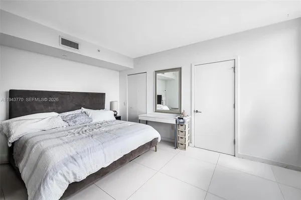 a bedroom with a bed and a closet