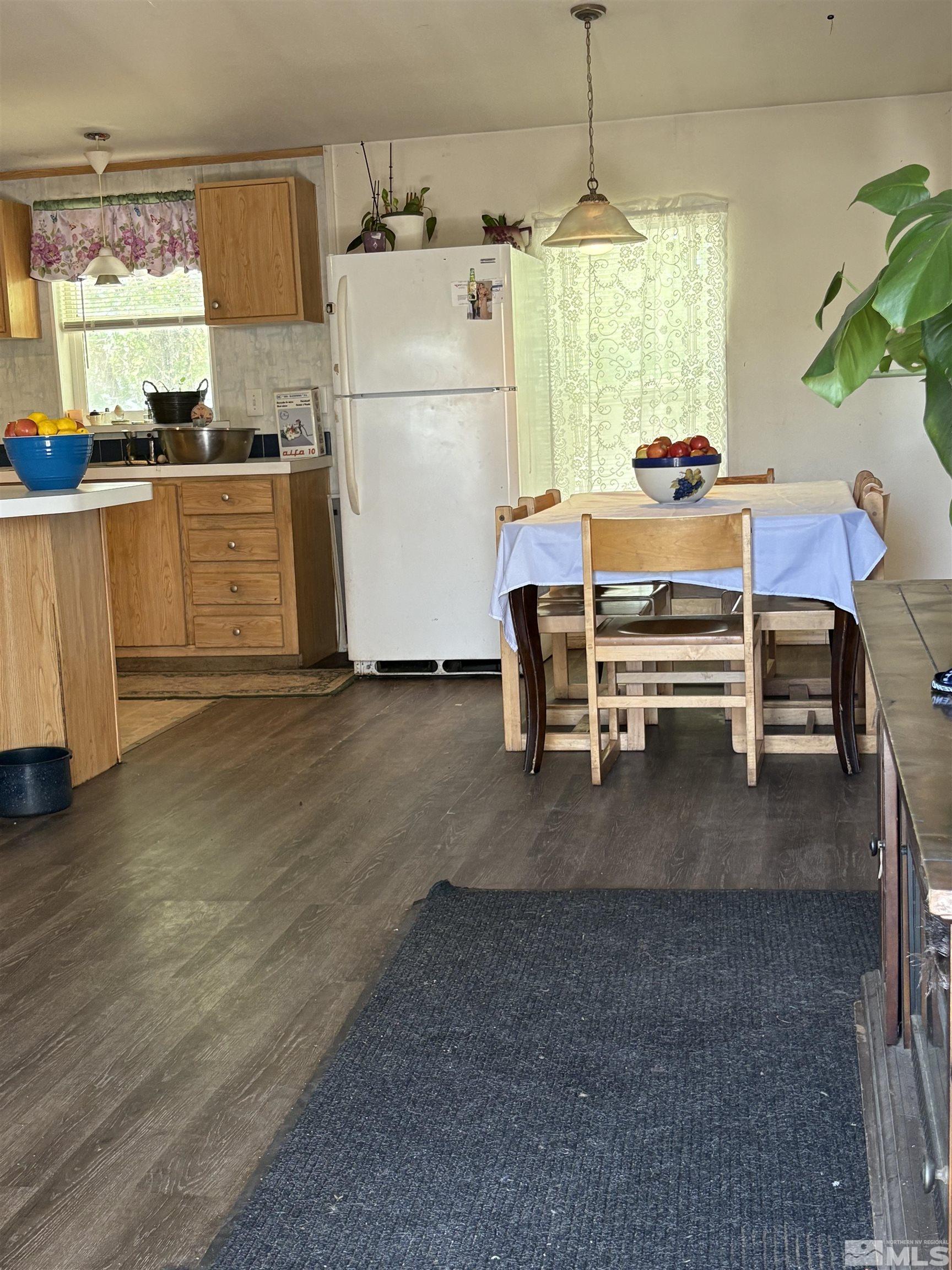 3715 Sandpiper Drive Reno, NV 89508 - Photo 5 of 6 a kitchen with a refrigerator a stove a sink dishwasher with a dining table and chairs
