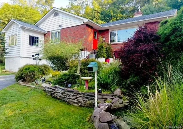 a view of a house with a yard and plants