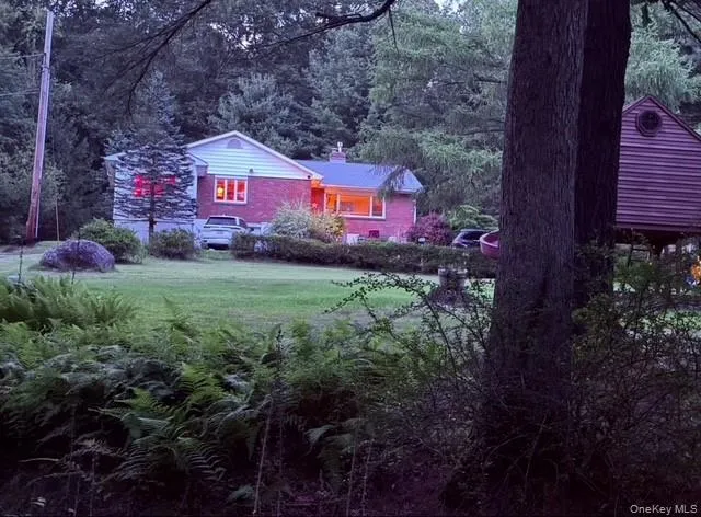 a view of a house with a yard and sitting area