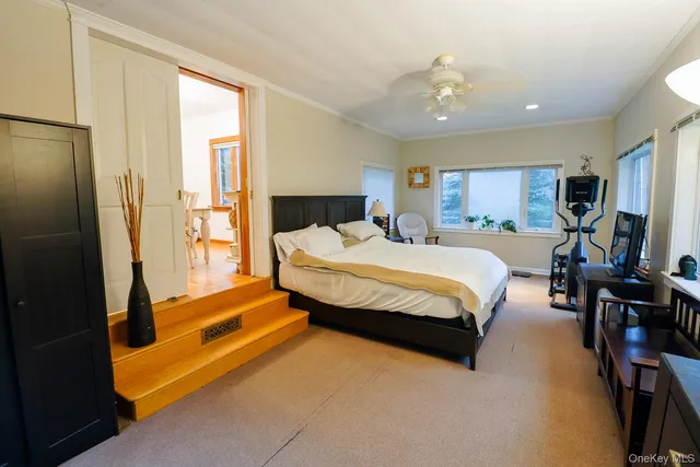 a spacious bedroom with a bed and a chandelier