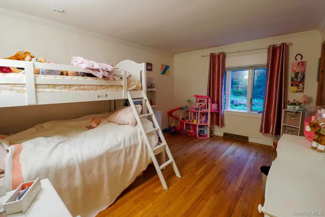 a bed sitting in a bedroom next to a window