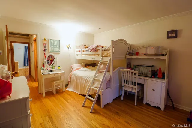 a bedroom with furniture and wooden floor
