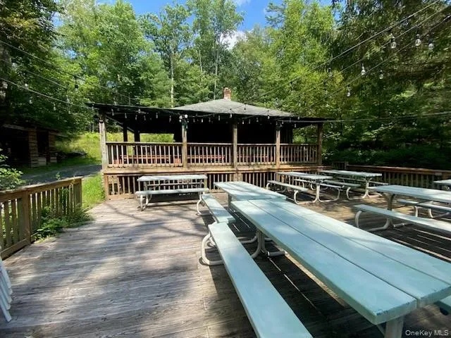 a view of backyard with deck and outdoor seating