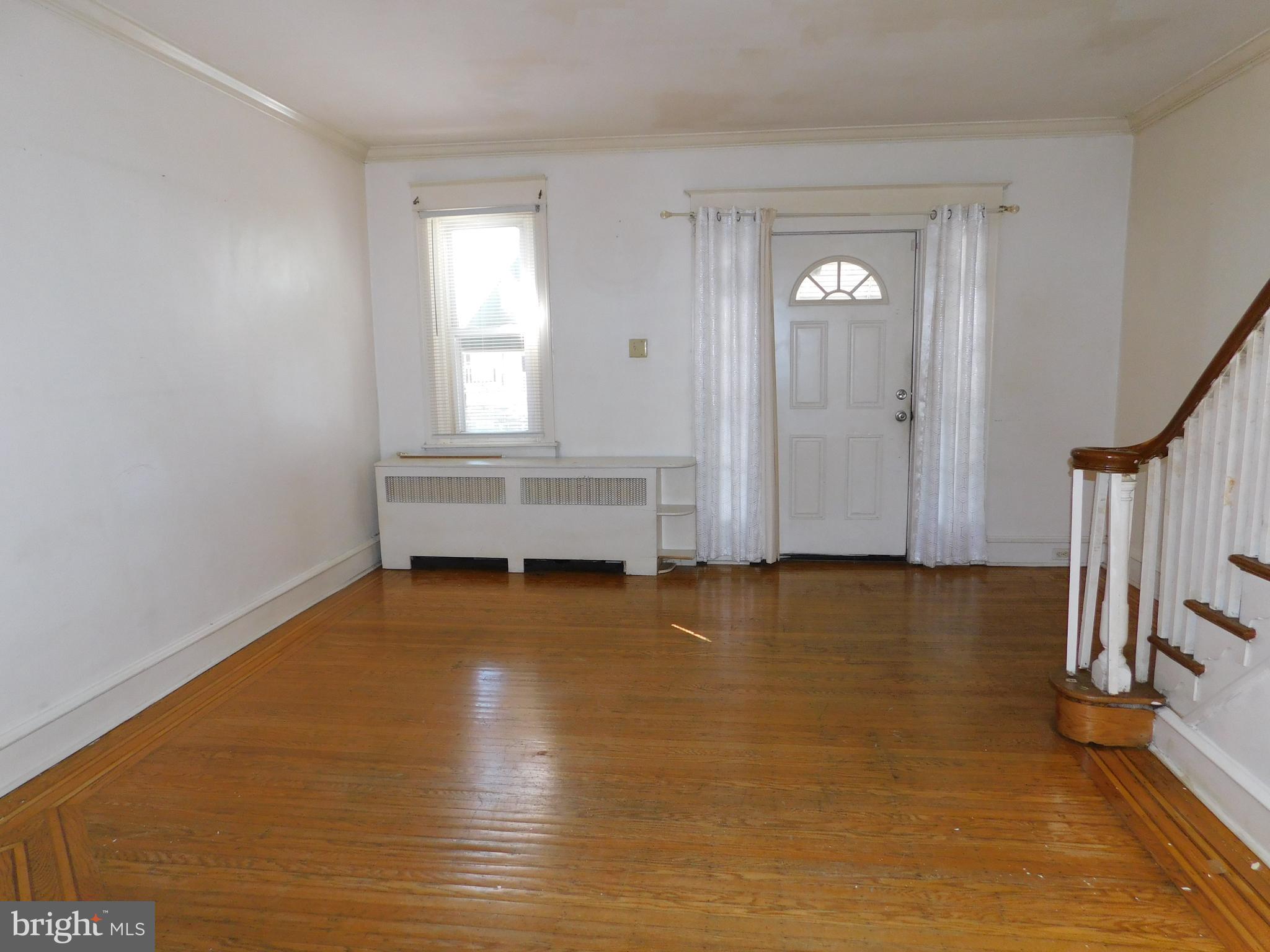 229 Huntley Road Upper Darby, PA 19082 - Photo 3 of 17 a view of room with window and wooden floor