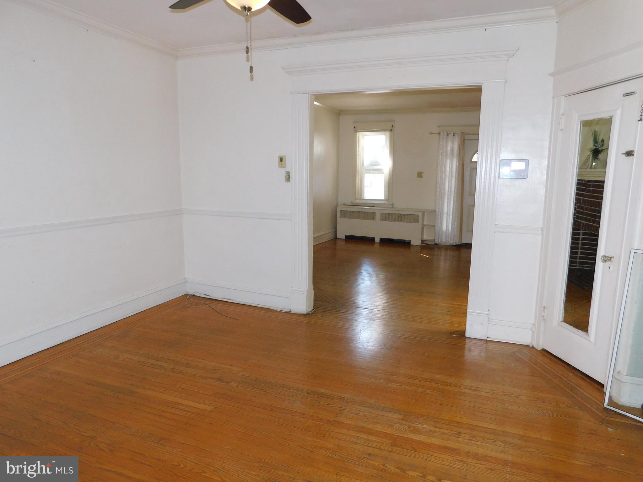 229 Huntley Road Upper Darby, PA 19082 - Photo 5 of 17 a view of empty room with wooden floor and fan