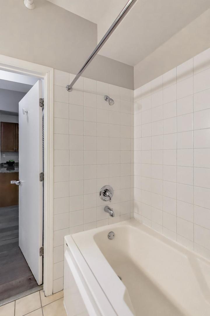 1155 South State Street, Unit C404 Chicago, IL 60605 - Photo 11 of 18 a bathroom with a tub a sink and a shower