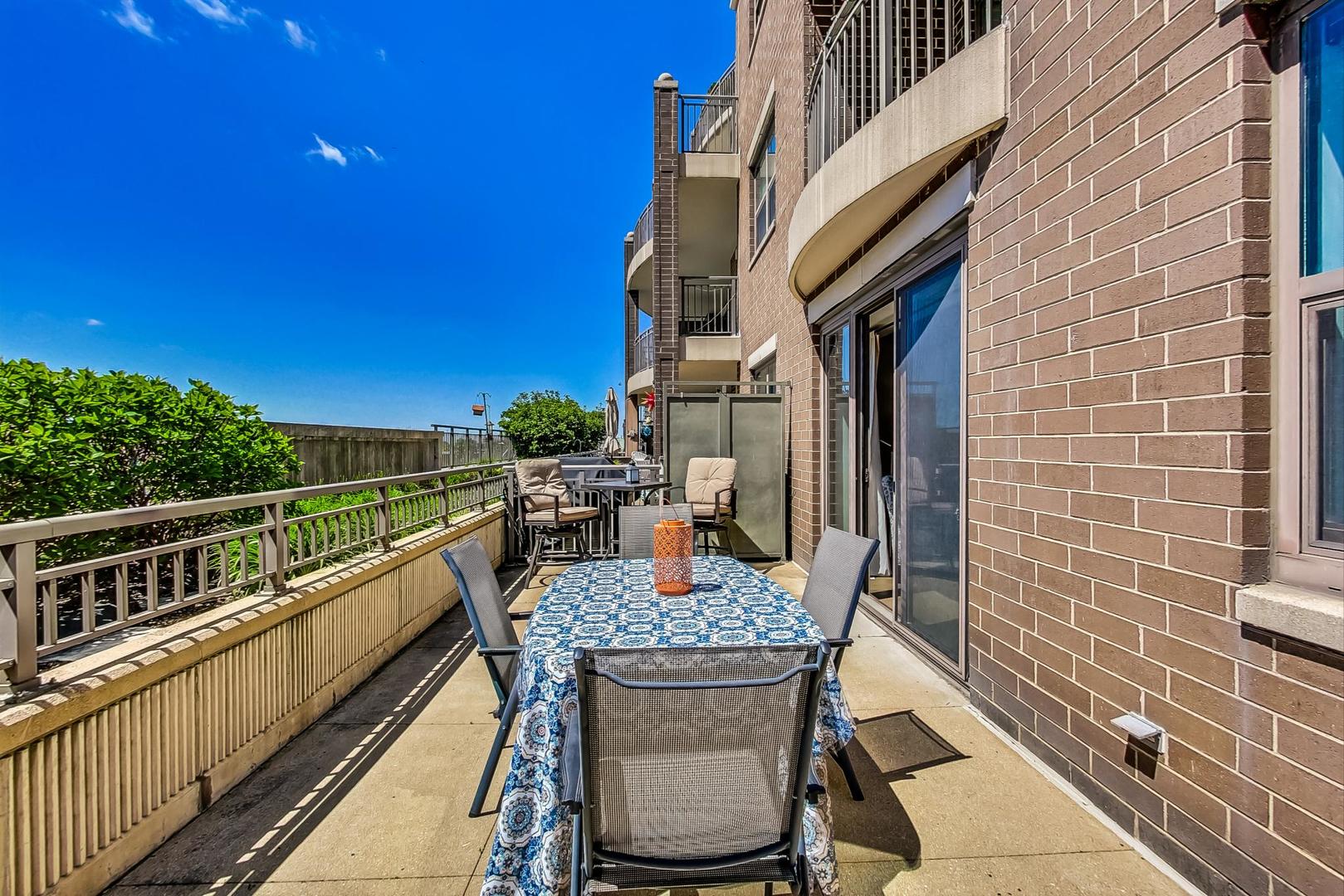 1155 South State Street, Unit C404 Chicago, IL 60605 - Photo 13 of 18 a balcony with table and chairs
