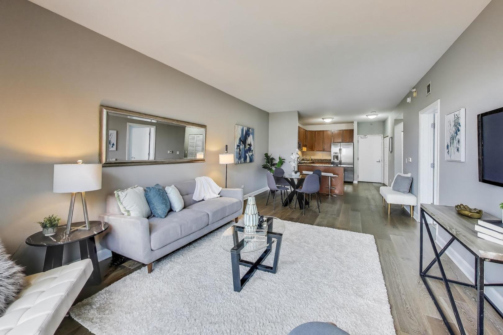 1155 South State Street, Unit C404 Chicago, IL 60605 - Photo 3 of 18 a living room with furniture and a table