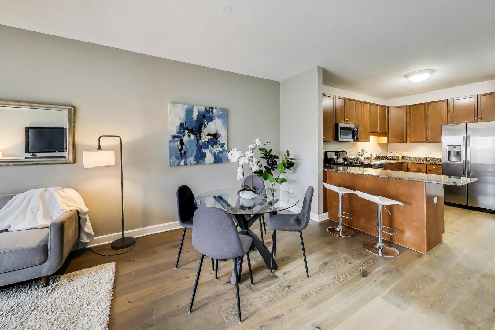 1155 South State Street, Unit C404 Chicago, IL 60605 - Photo 5 of 18 a view of a dining room with furniture and a kitchen