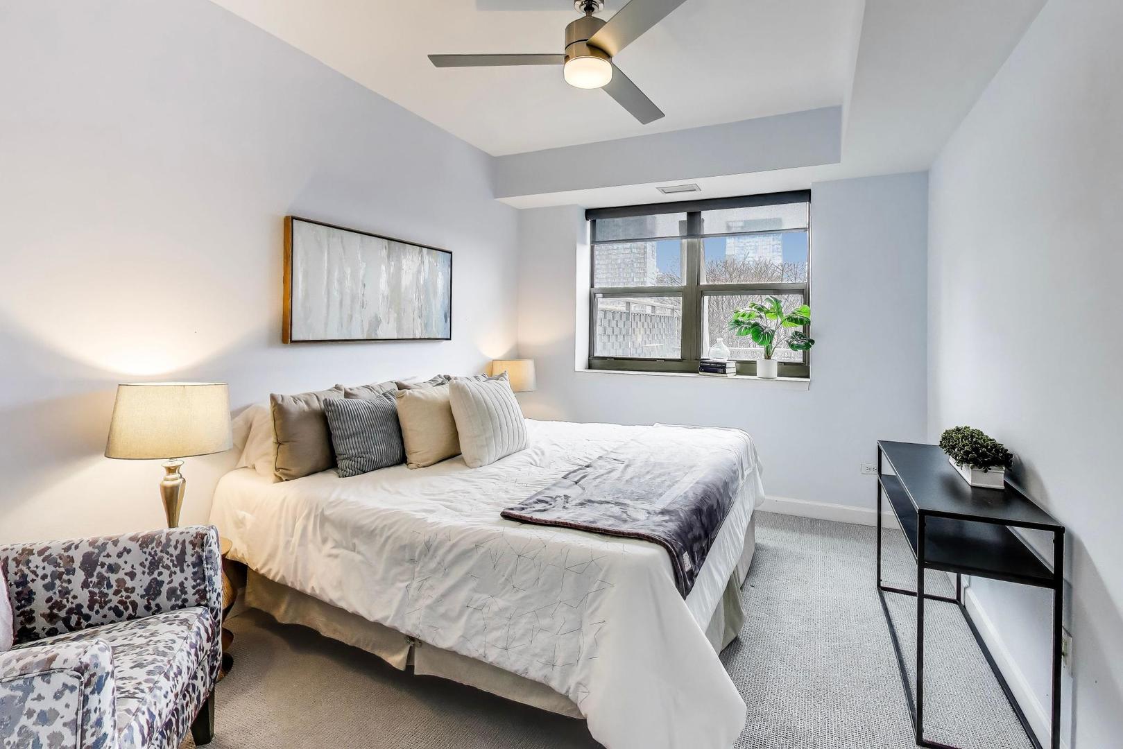 1155 South State Street, Unit C404 Chicago, IL 60605 - Photo 7 of 18 a bedroom with a bed and a window