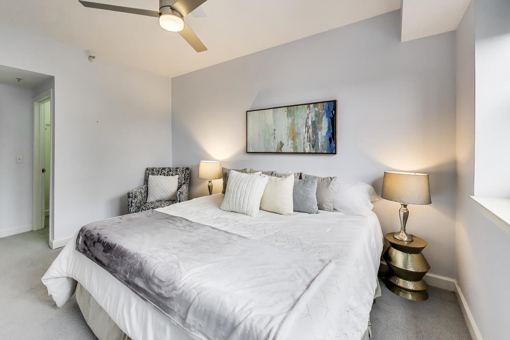 1155 South State Street, Unit C404 Chicago, IL 60605 - Photo 8 of 18 a bedroom with a bed and lamp