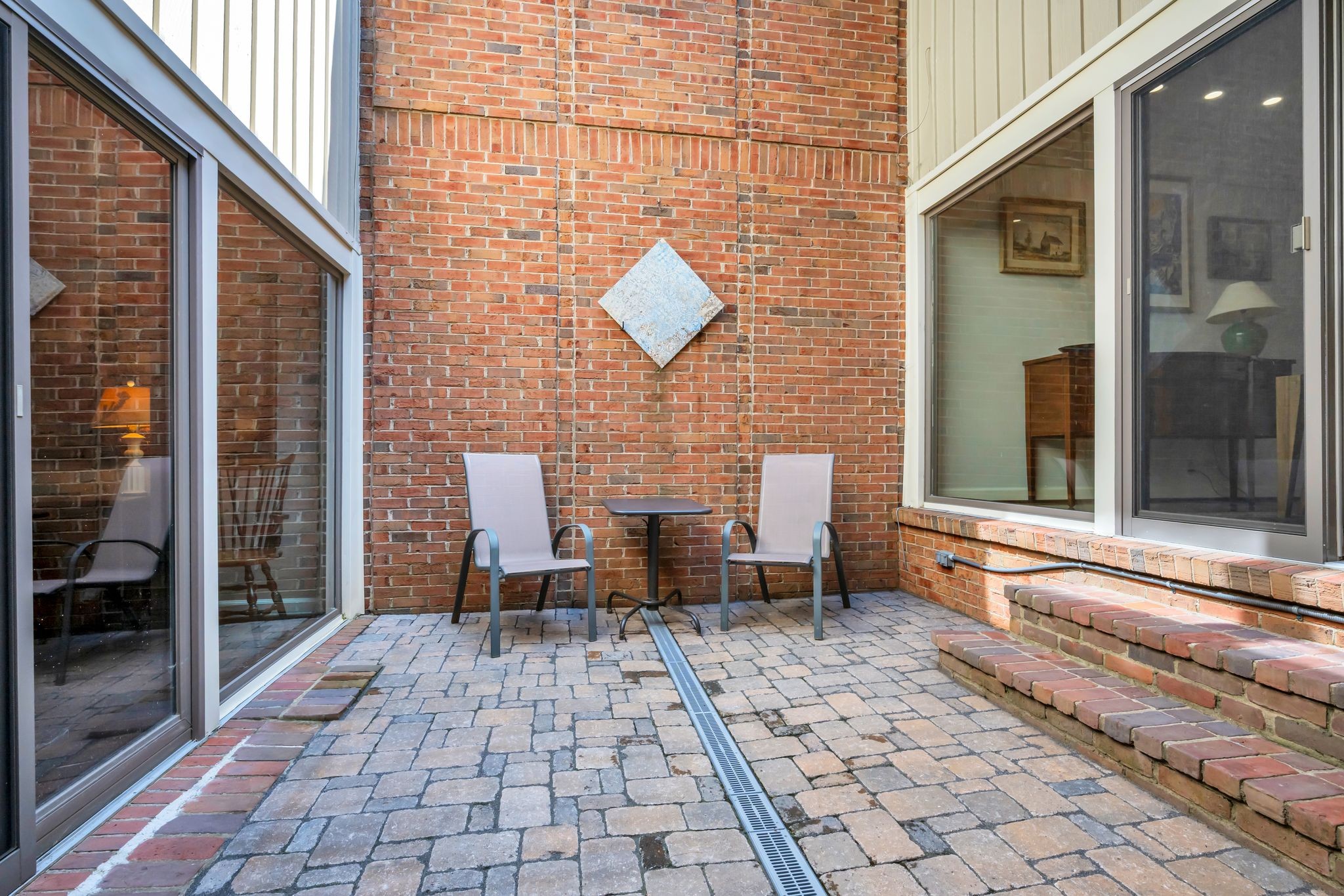 694 Timber Lane Nashville, TN 37215 - Photo 17 of 30 a view of a brick house with a chairs and table in a patio