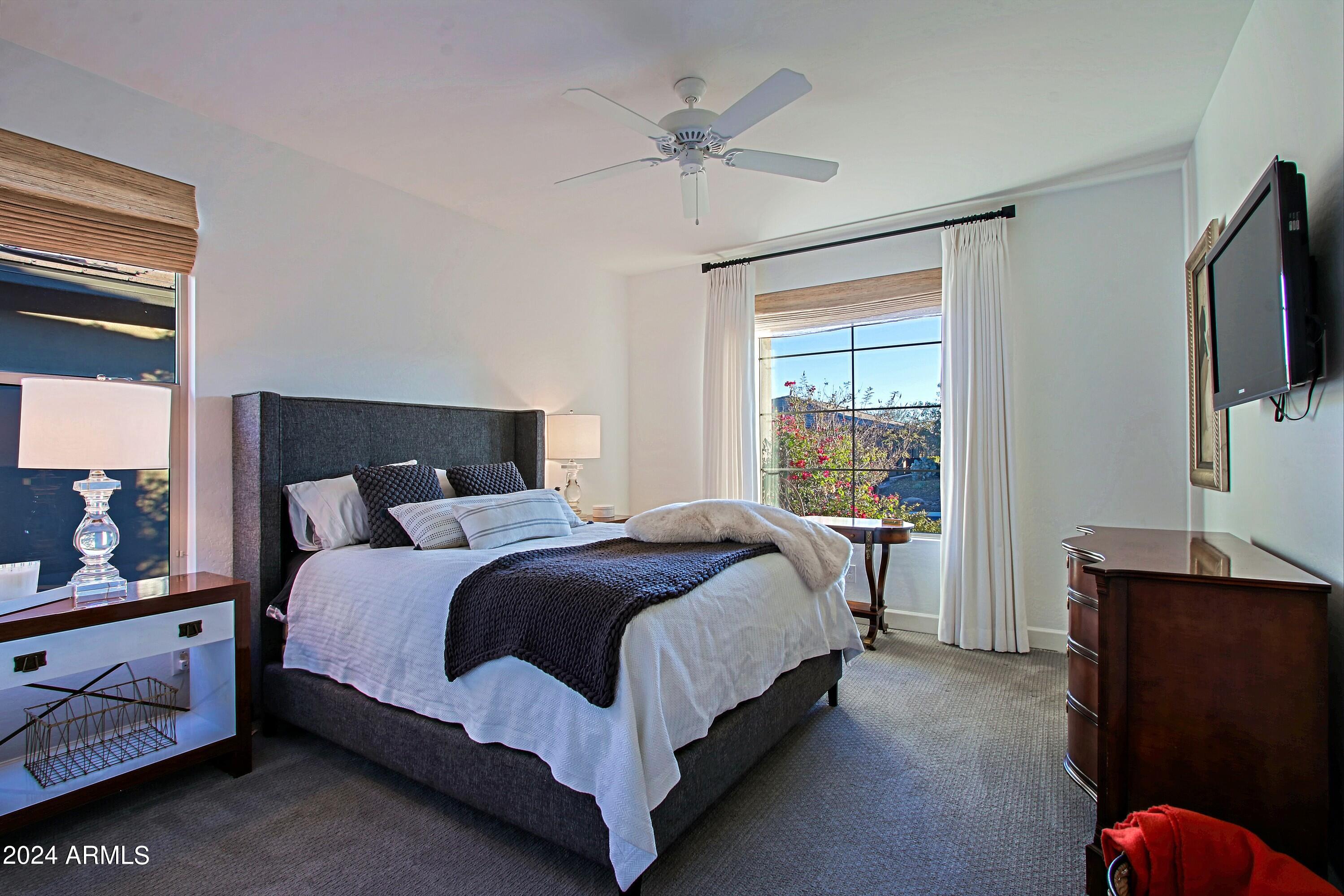 17674 East Fort Verde Road Rio Verde, AZ 85263 - Photo 25 of 42 a bedroom with a bed and a flat tv screen on dresser