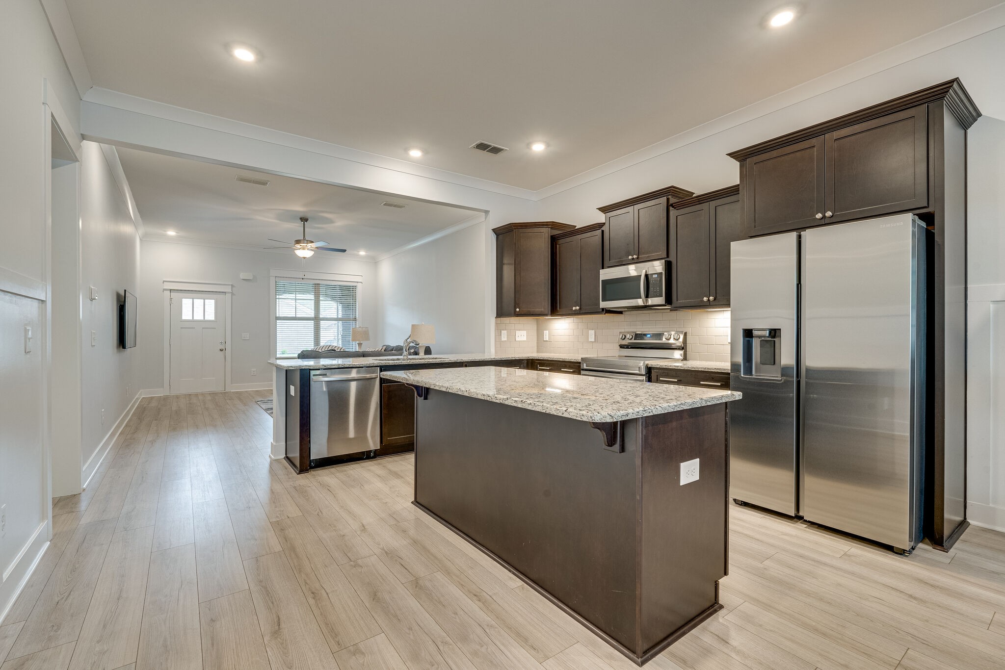 2125 Halfmoon Way Murfreesboro, TN 37130 - Photo 11 of 33 a kitchen with stainless steel appliances kitchen island granite countertop a refrigerator a sink dishwasher a stove and a refrigerator with wooden floor