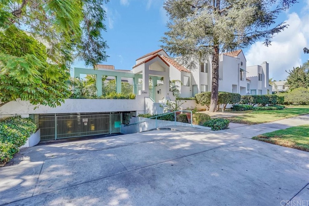 1340 Glenwood Road, Unit 8 Glendale, CA 91201 - Photo 1 of 1 a front view of a house with a yard and garage