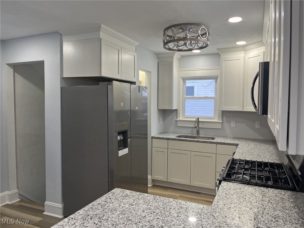 3264 Altamont Road Cleveland, OH 44118 - Photo 2 of 32 Kitchen featuring stainless steel appliances, light stone countertops, recessed lighting, light wood-style floors, and white cabinetry