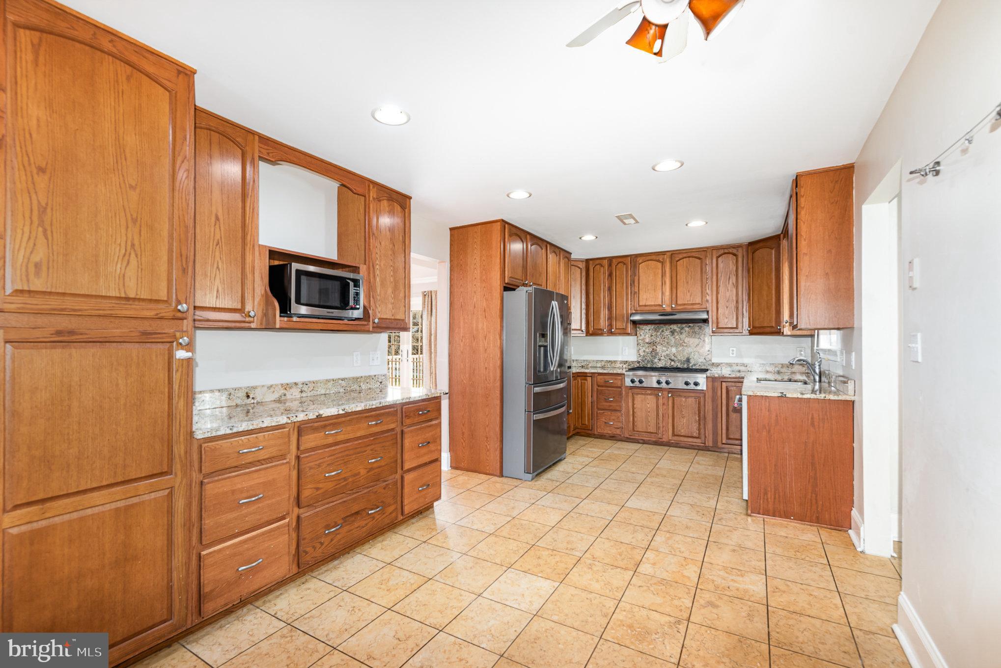 4617 Forge Road Perry Hall, MD 21128 - Photo 16 of 44 a kitchen with stainless steel appliances a refrigerator sink and microwave